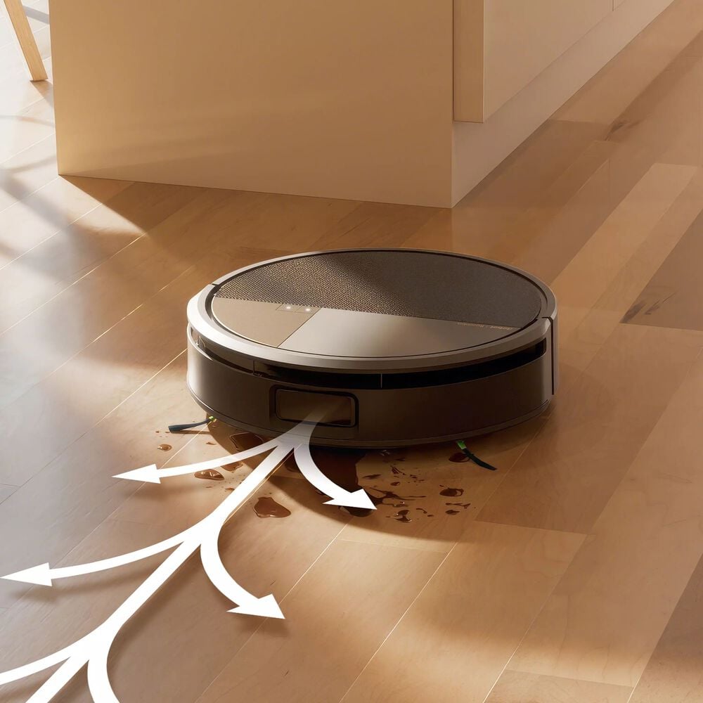 Robot aspirador gris limpiando derrame en suelo de madera con flechas de succión