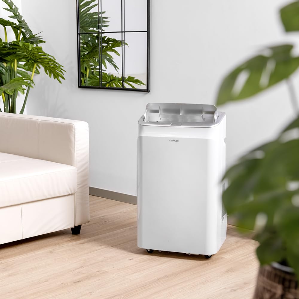 Aire acondicionado portátil Cecotec en salón moderno con plantas.