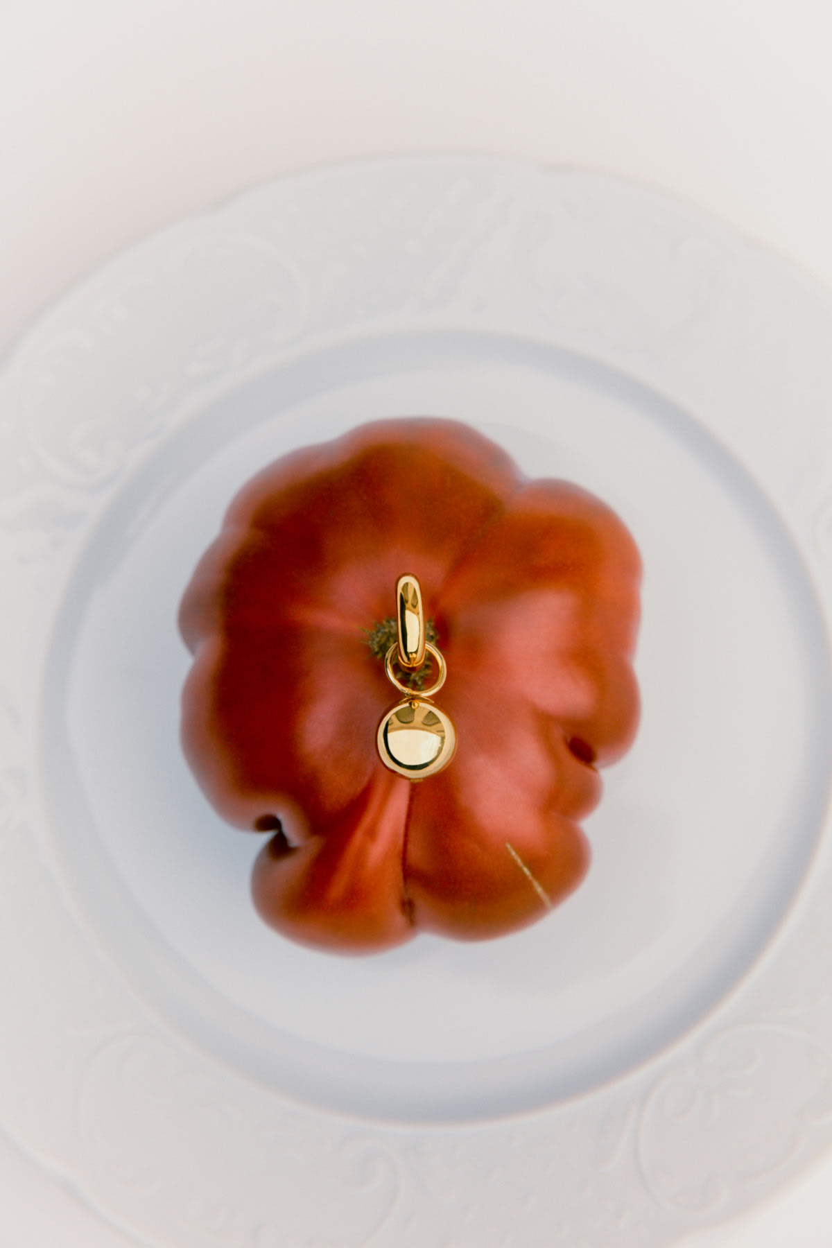earring balancing on tomato