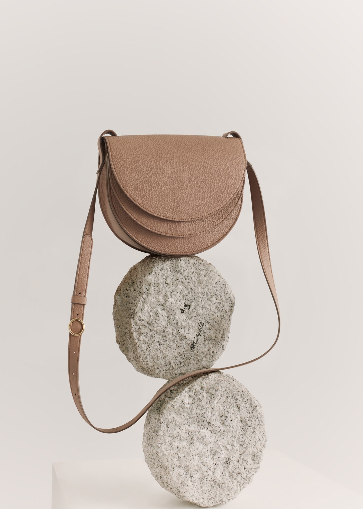 leather bag balancing on stones