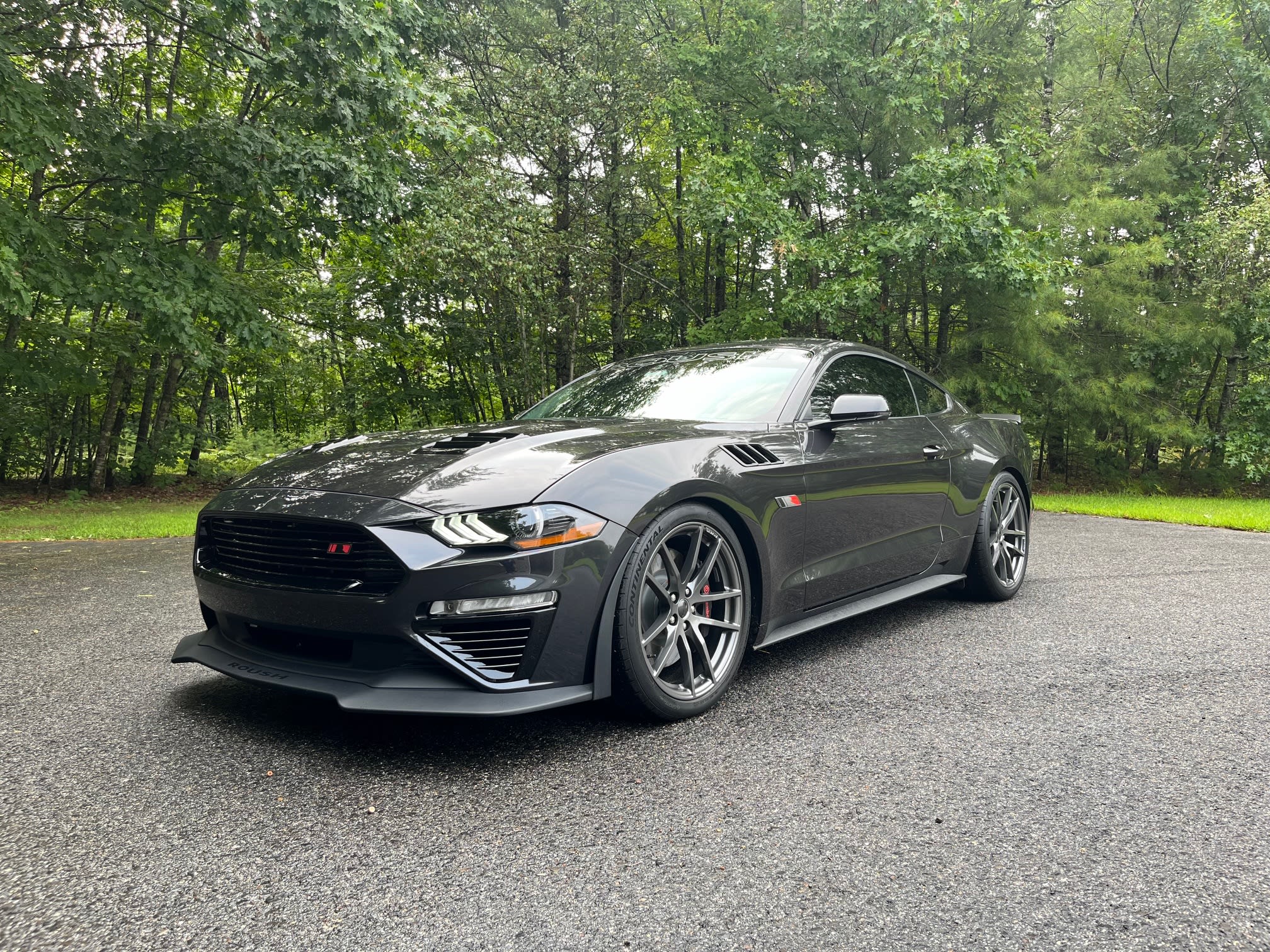 Black Ford Mustang coupe with tinted windows