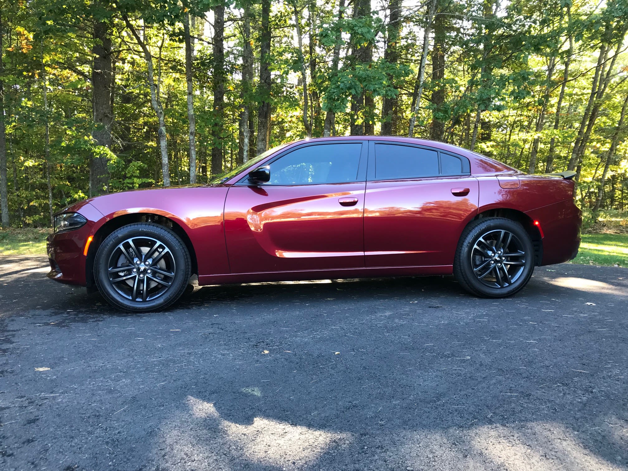 Maroon Dodge Charger sedan with tinted windows