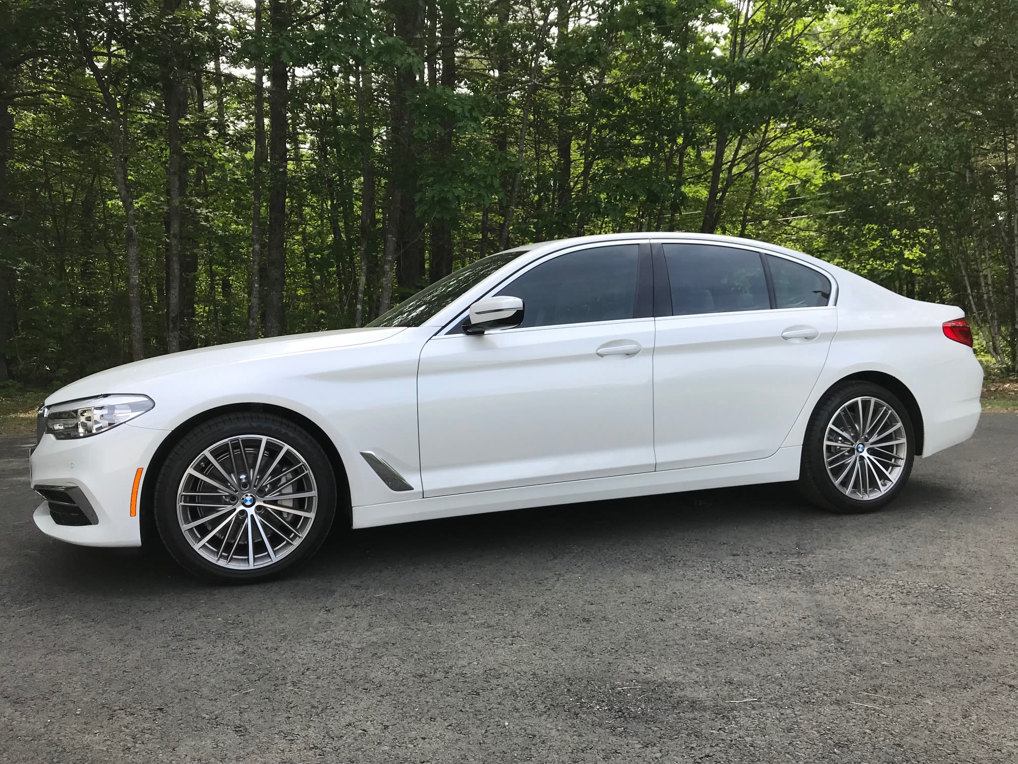 White BMW 5 Series sedan with tinted windows