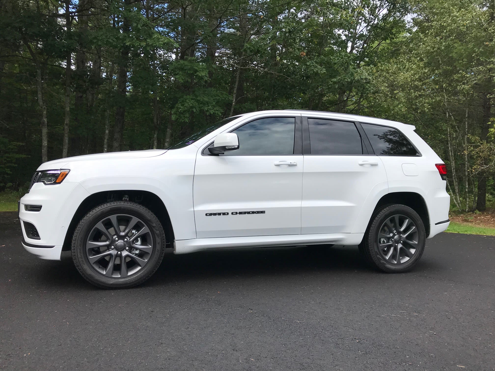 White Jeep Grand Cherokee SUV with tinted windows