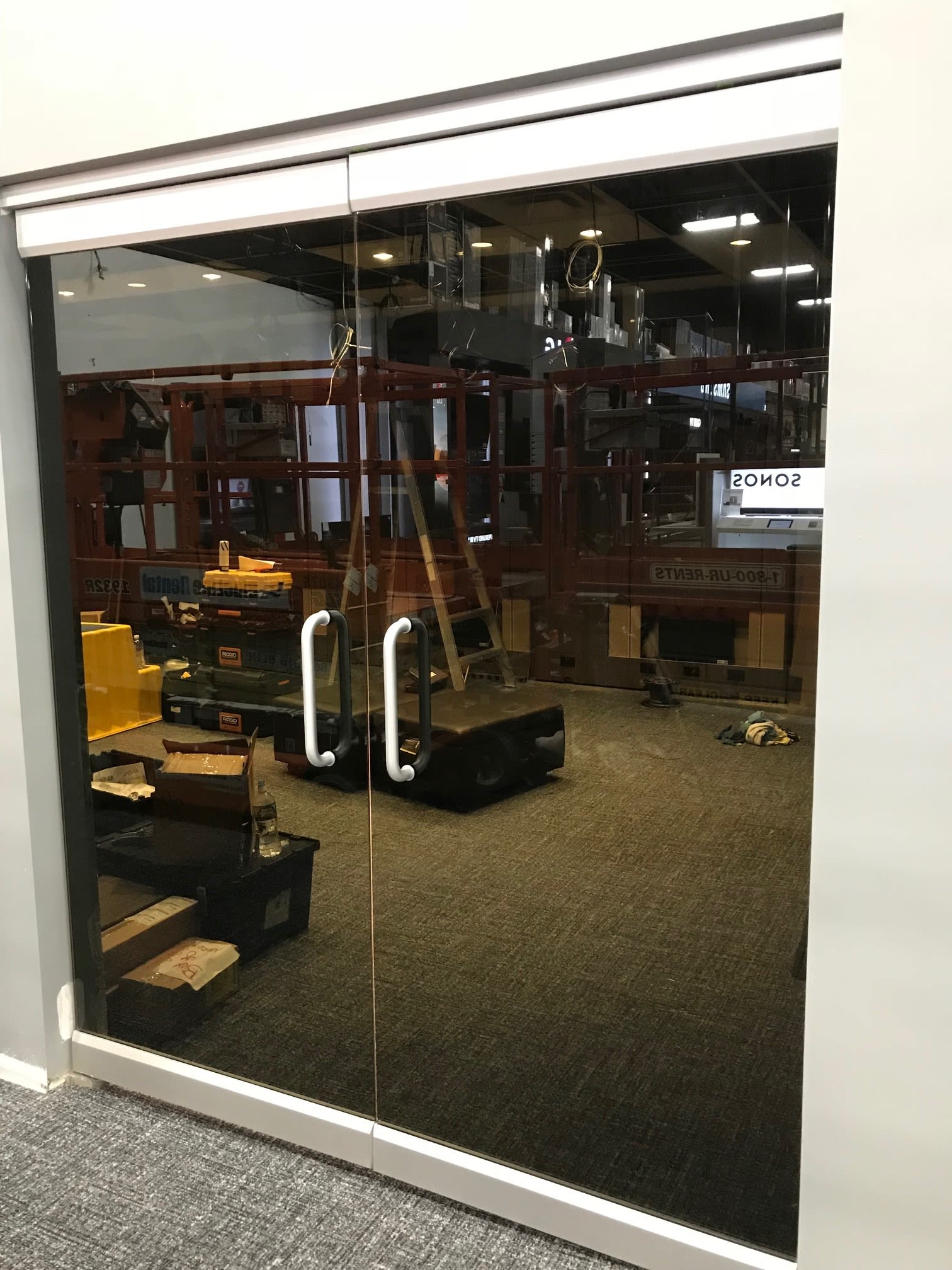 Frameless glass office partition wall with dark tinted film
