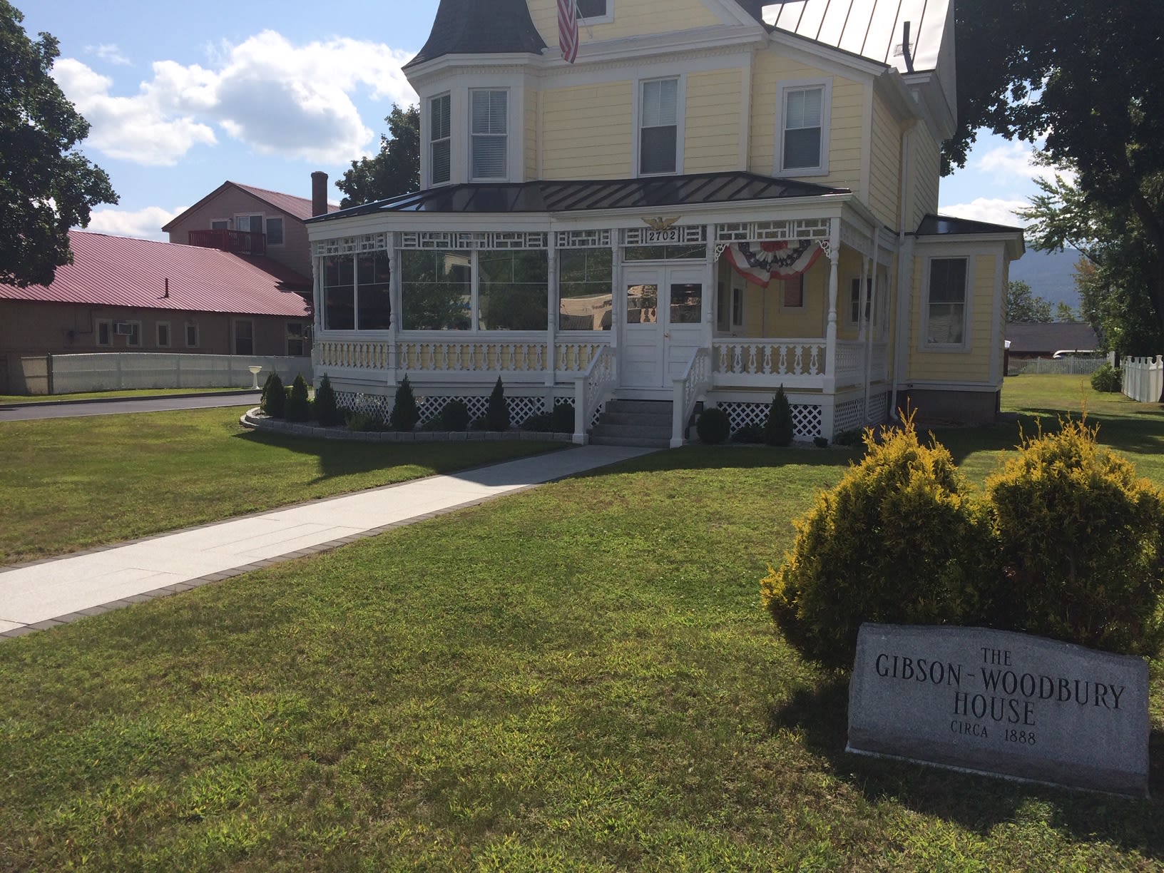 Historic Gibson-Woodbury House with tinted wraparound porch windows