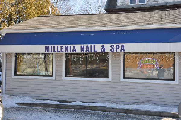 Millenia Nail and Spa storefront with blue awning windows