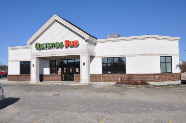 Quiznos Sub restaurant building with tinted storefront windows
