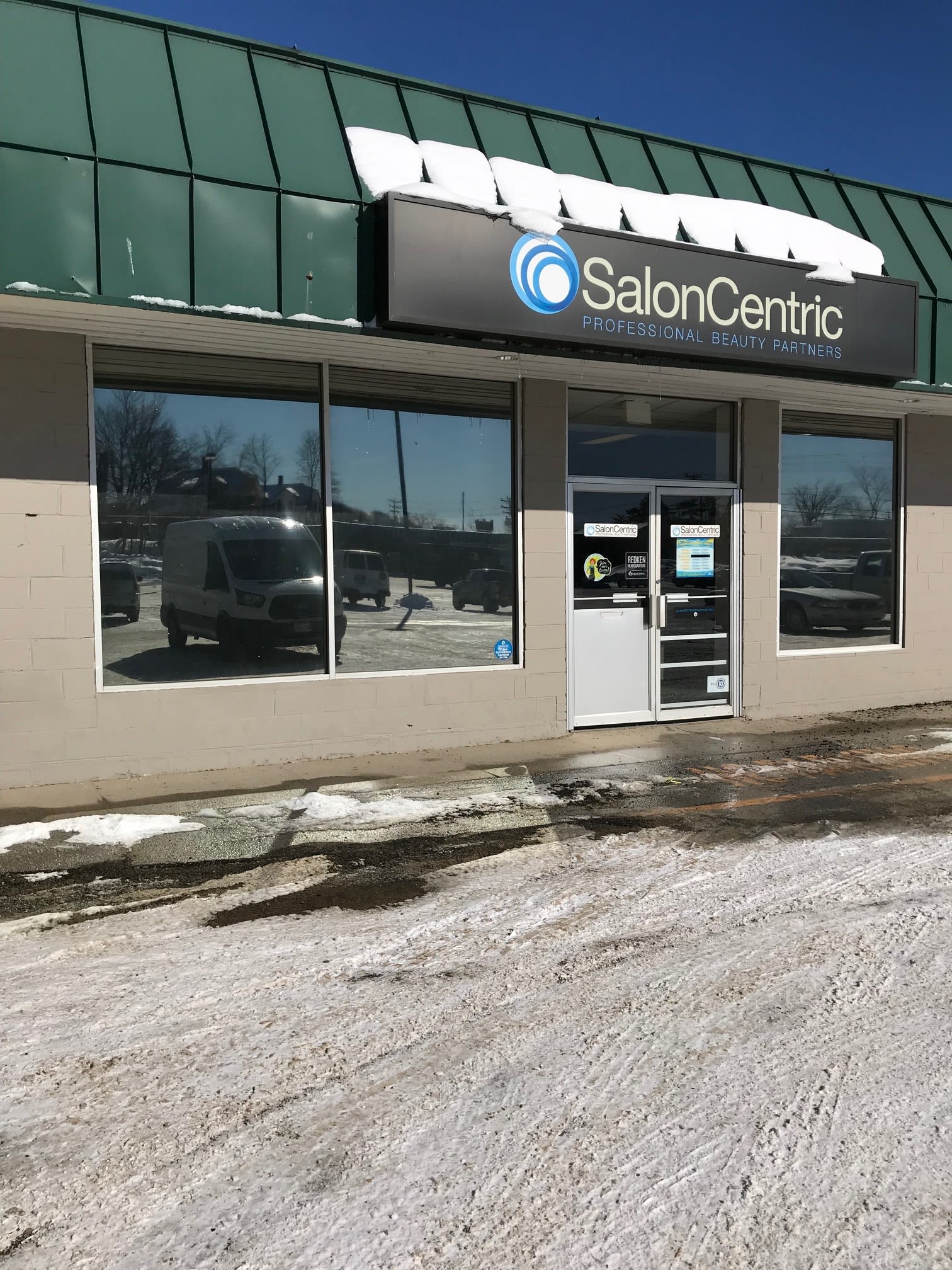 SalonCentric storefront with tinted retail display windows