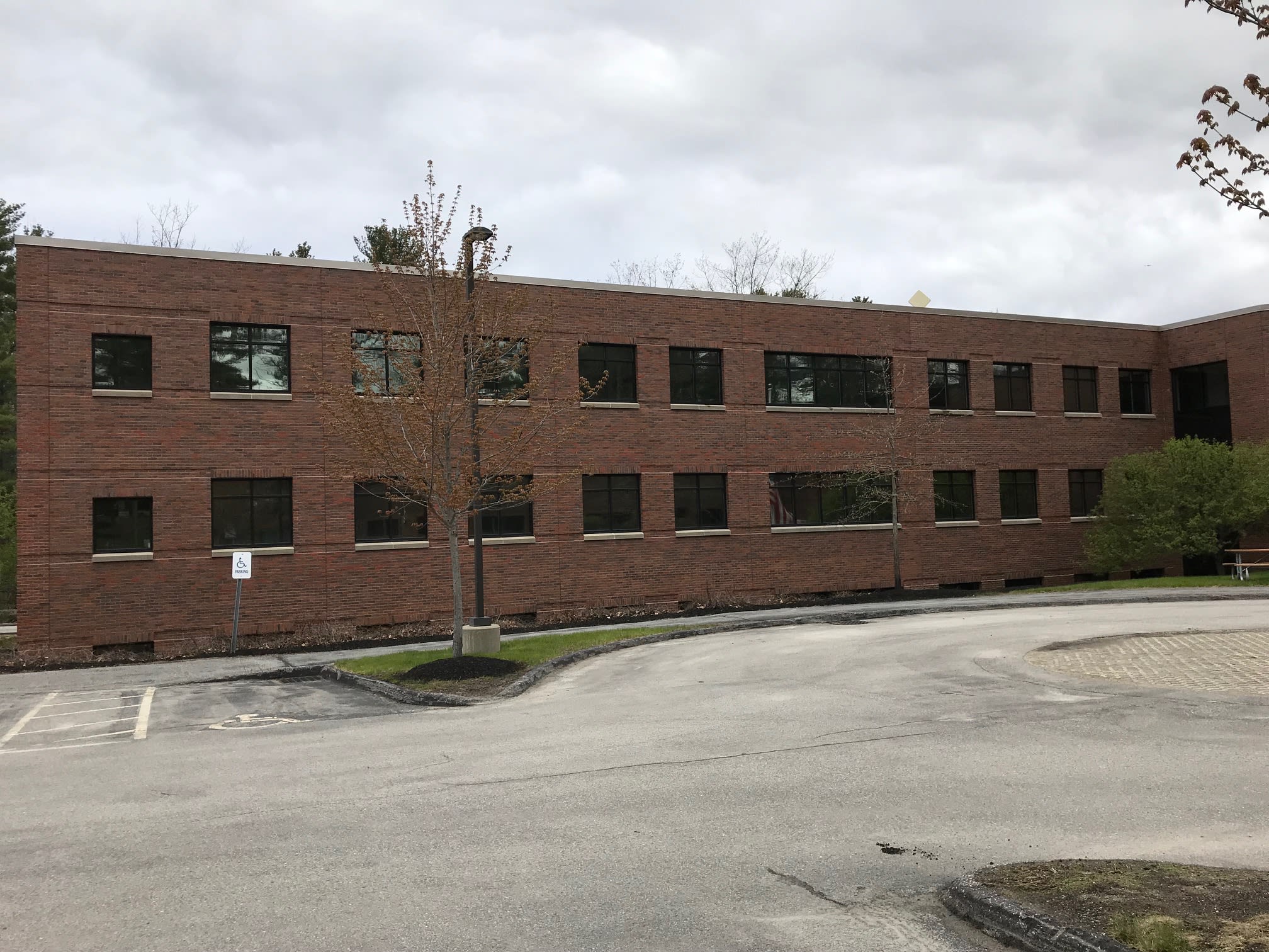 Two-story brick office building with tinted exterior windows