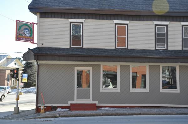 Two-story commercial building with tinted storefront windows