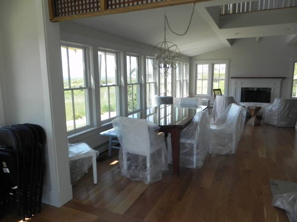 Coastal dining room with large windows and water view