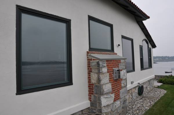 Home exterior windows with tinted glass facing ocean