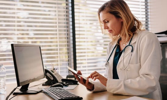 physician working on appointment reminder software