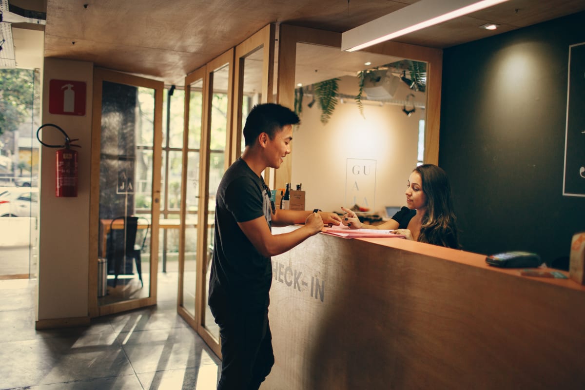 Receptionist checking in patient because appointment reminder worked