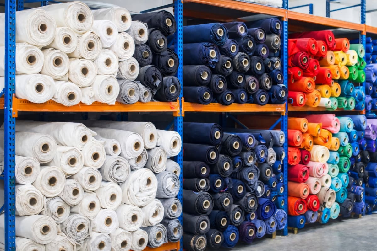 Shelves of fabric rolls in white, navy and bright colours