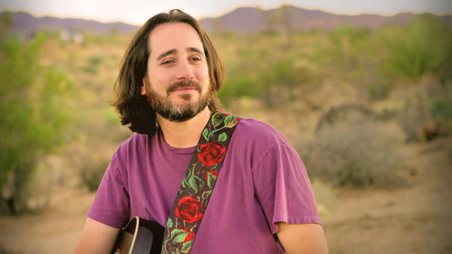 David Newman — Bearded musician with guitar outdoors