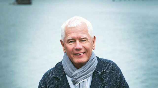 Frank Ostaseski — Man smiling by waterfront railing