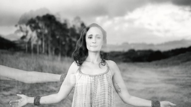 Jai-Jagdeesh — Woman with outstretched arms in scenic landscape