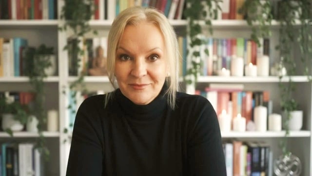 Karen Frances McCarthy — Professional portrait against bookshelf backdrop