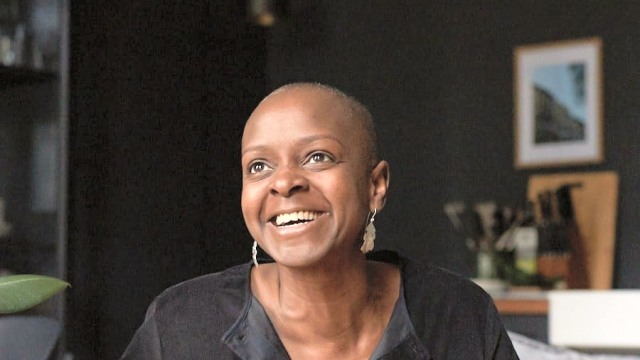 Kemi Nekvapil — Woman smiling on couch indoors