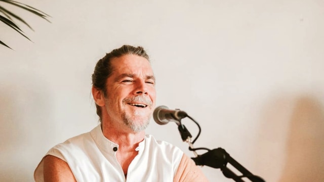 Kevin James Carroll — Musician performing with acoustic guitar and microphone