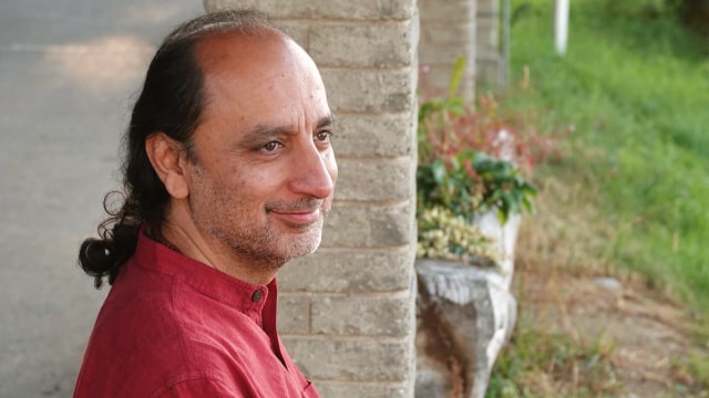 Manish Vyas — Man in profile by brick wall
