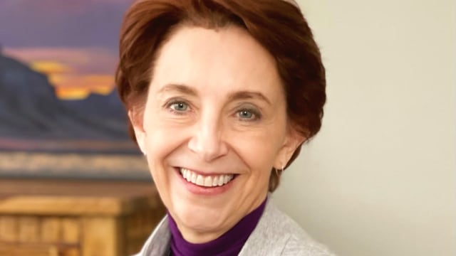 Martha Beck — Professional headshot with scenic backdrop