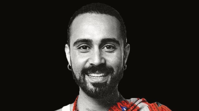 Sah D'Simone — Bearded man in traditional red garment