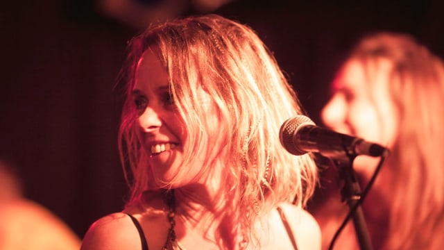 Vanessa Forbes — Woman performing at stage microphone