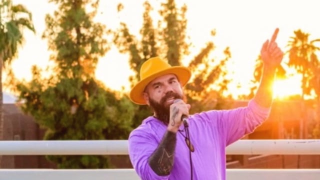 Yogi Bryan — Man performing with microphone at sunset