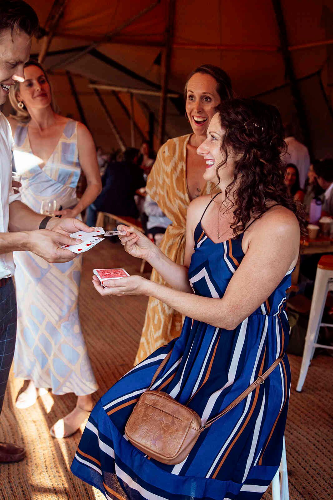 wedding_guest_receiving_playing_cards_tipi_reception_entertainment_54a6b5329e