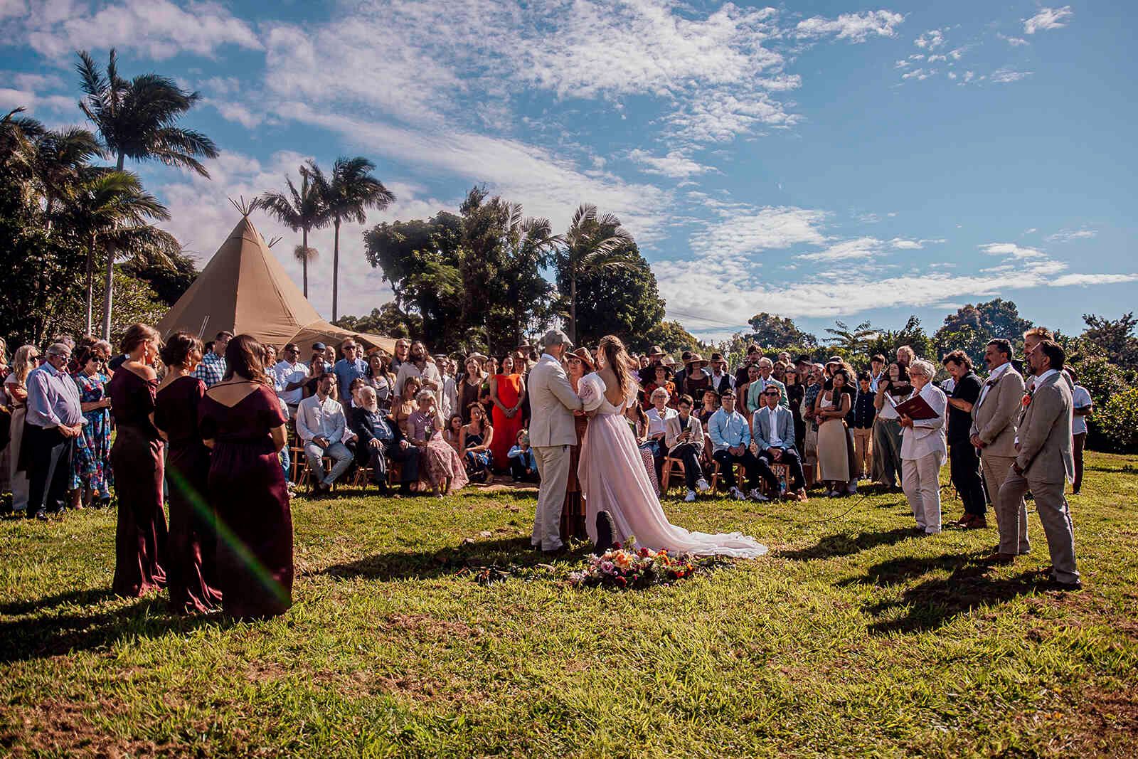 wide_view_wedding_ceremony_large_guest_crowd_teepee_tent_d0db808264