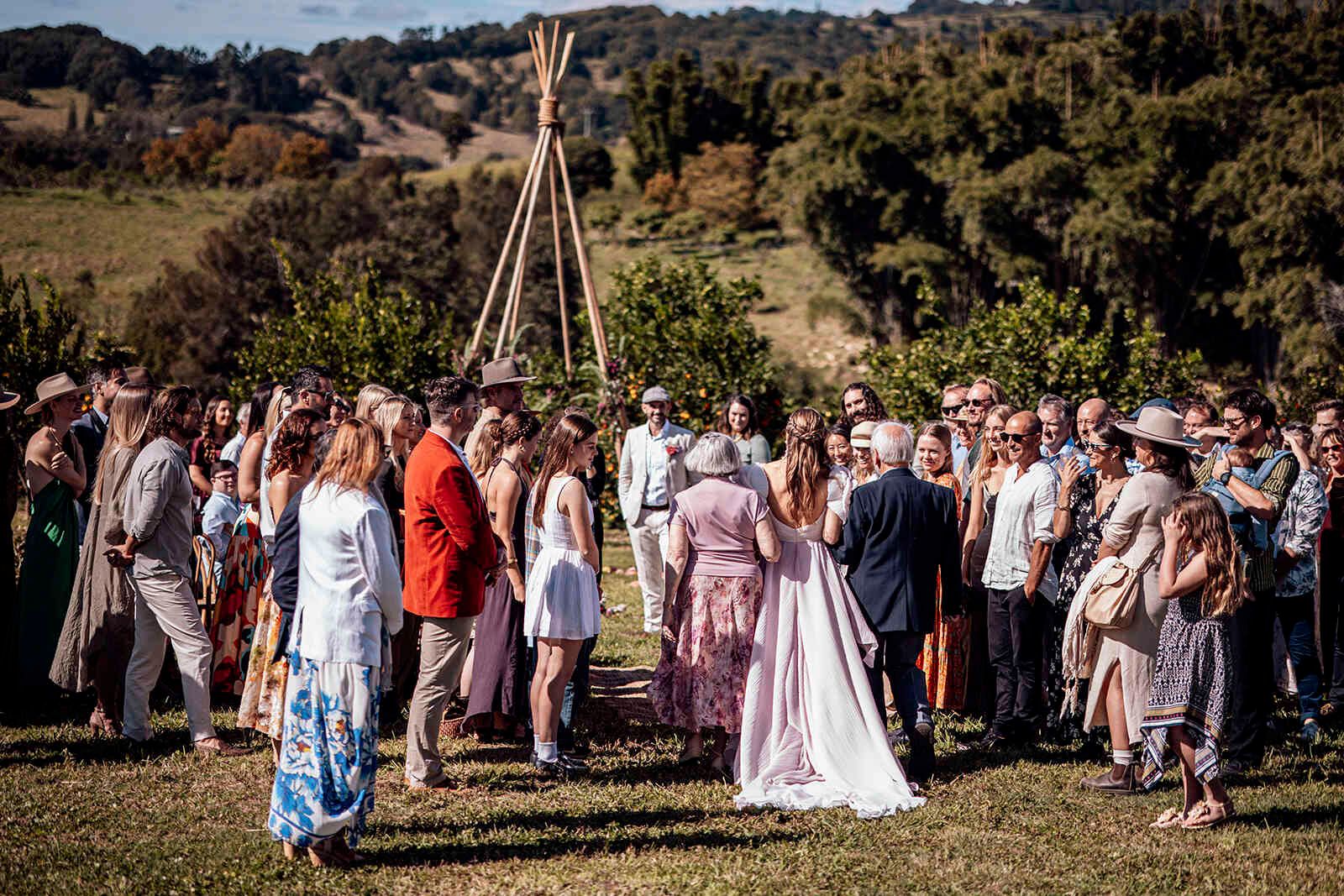 wedding_guests_outdoor_ceremony_teepee_arch_countryside_ffe633fc18