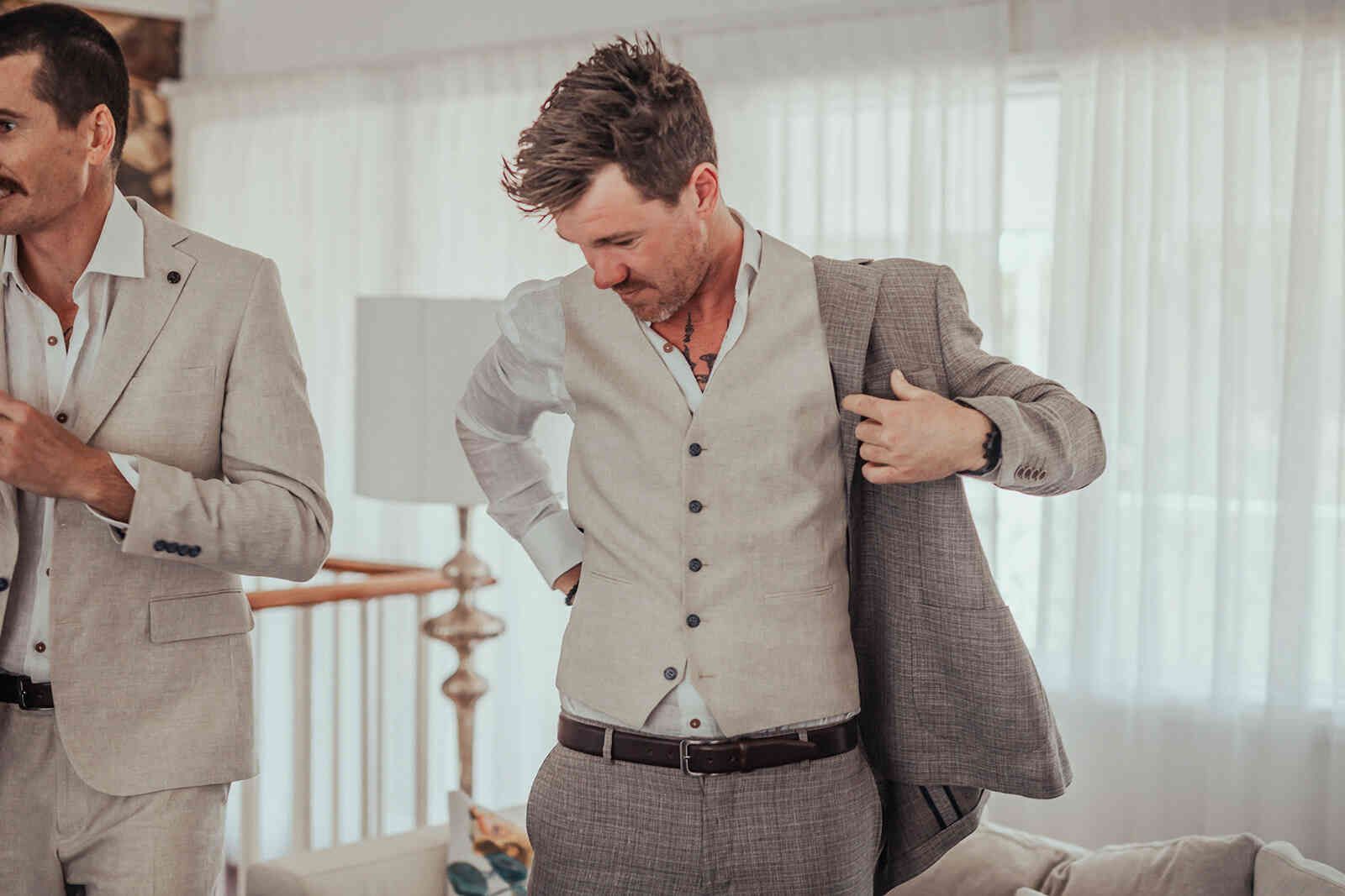 sarah_and_jeff_groom_jeff_getting_dressed_putting_on_jacket_4651665ed9