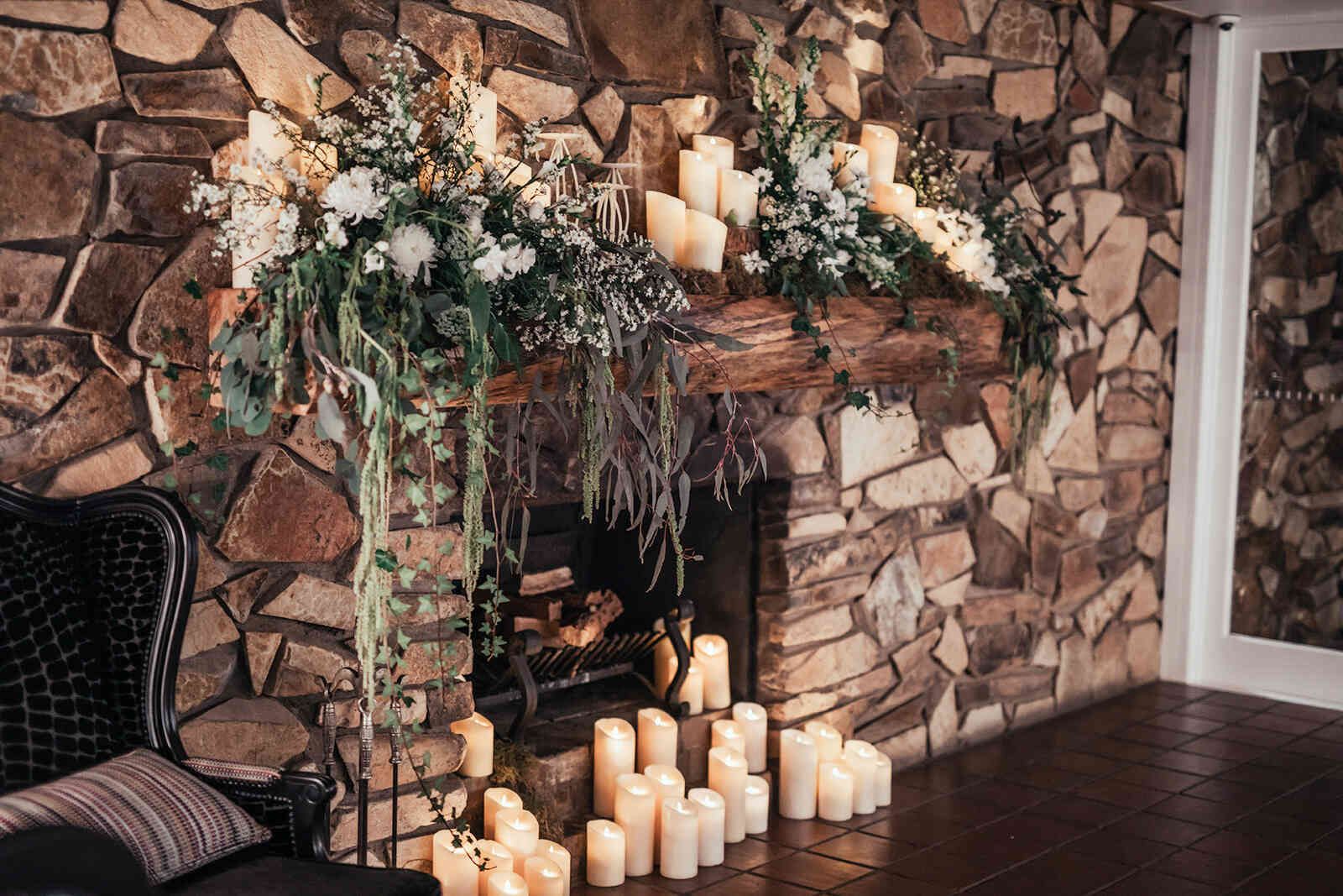 sarah_and_jeff_reception_stone_fireplace_decor_candles_wide_shot_a1ad0ff742
