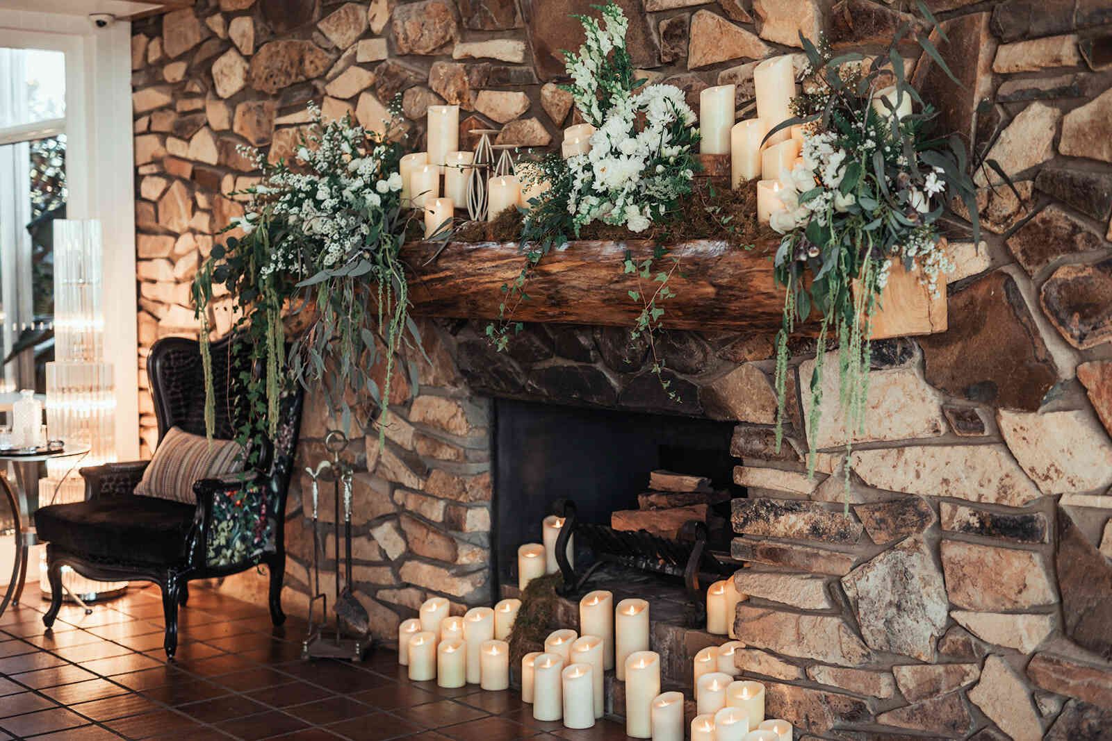 sarah_and_jeff_reception_fireplace_decor_candles_and_greenery_00f7ad3dde