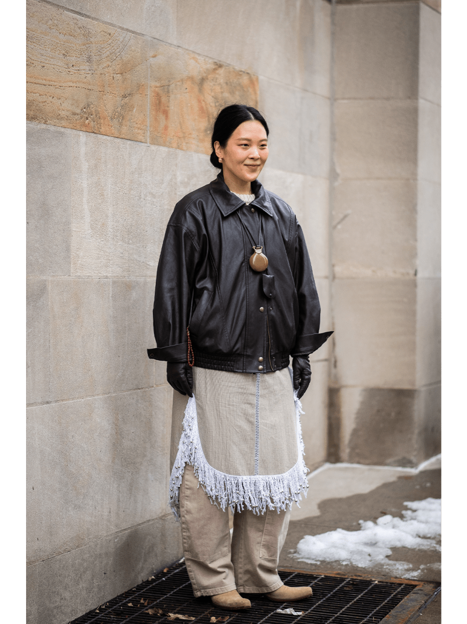 Frau in Lederjacke und Pendelkette