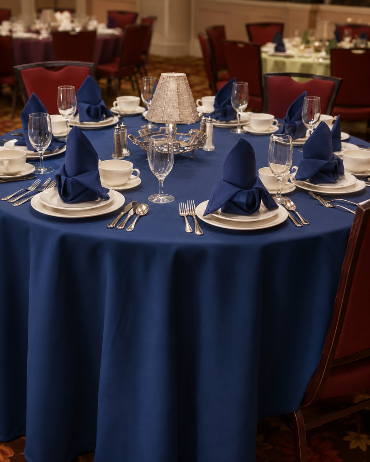 Banquet tables dressed with royal-blue fan-folded napkins