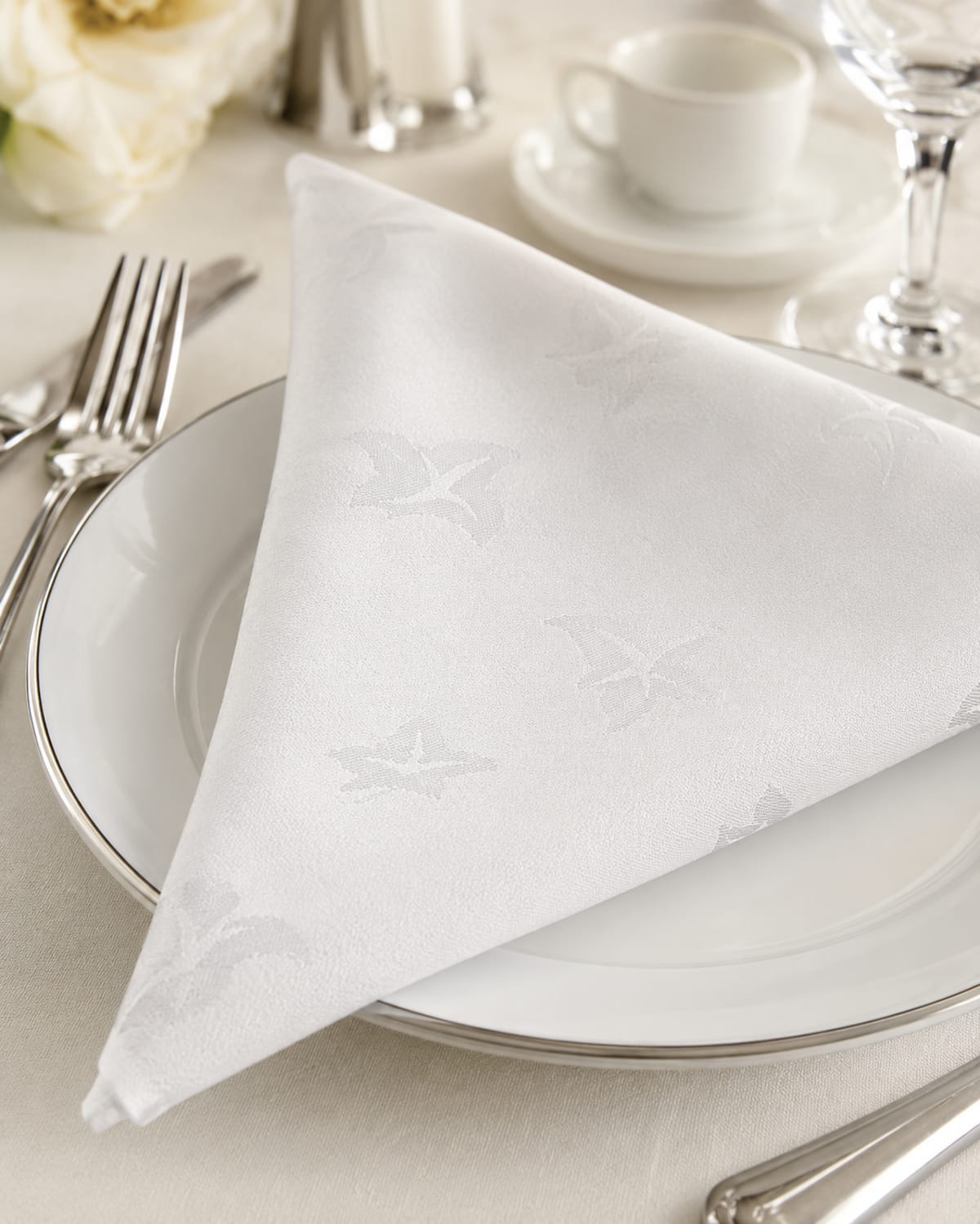 White damask napkin folded on a place setting