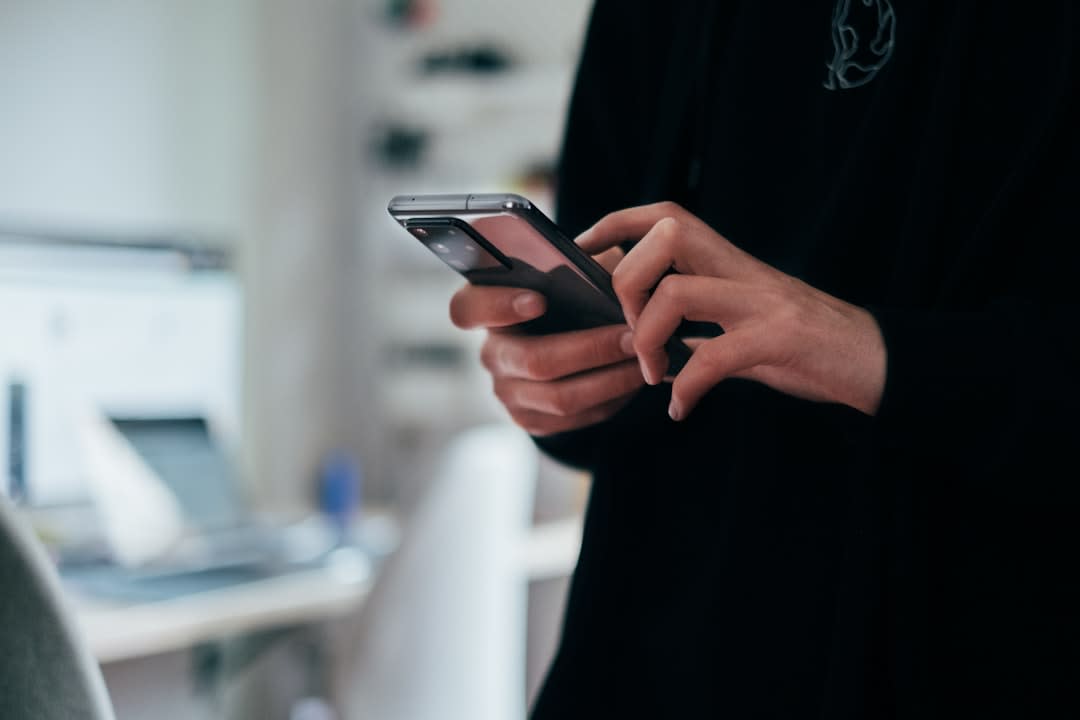 A person using a smartphone, representing consumer engagement with data privacy.