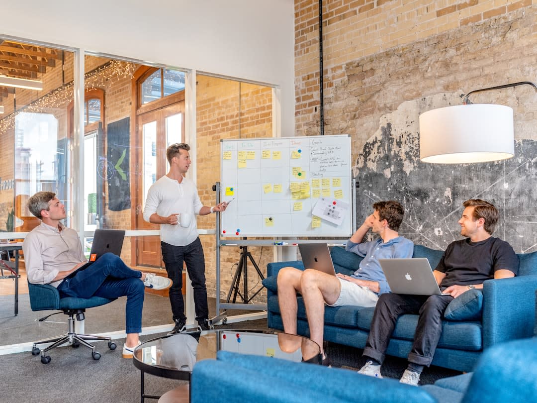 Entrepreneurs brainstorming business strategies in a modern workspace