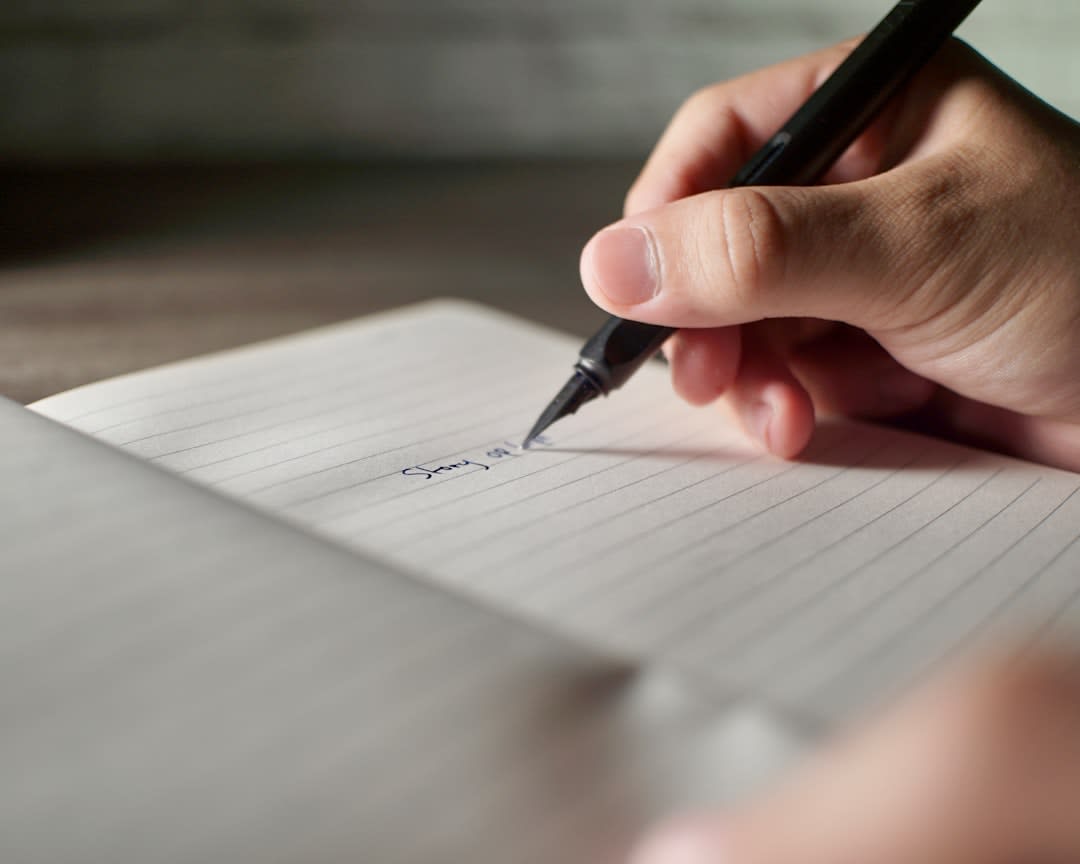 A person reflecting with a notebook and pen, symbolizing the concluding thoughts on writing.