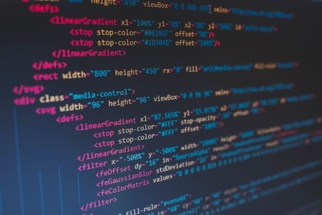 A close-up of hands typing on a laptop with code on the screen