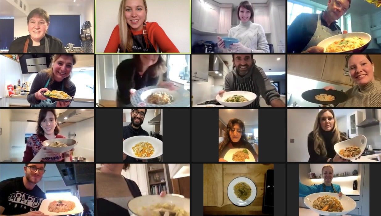 Virtual cooking class participants displaying their homemade dishes on video call