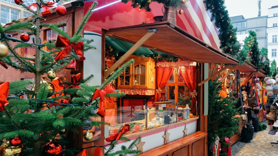 Festive Christmas market stall decorated with ornaments and garland outdoors
