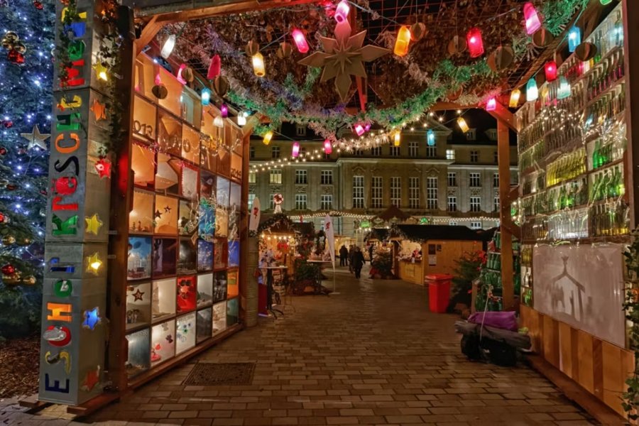 Luxembourg Christmas market entrance with festive lights and decorated stalls at night