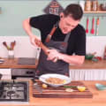 Professional chef cooking during virtual corporate team building cooking event