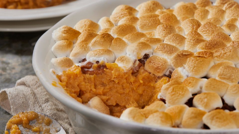 Sweet potato casserole topped with golden marshmallows in baking dish