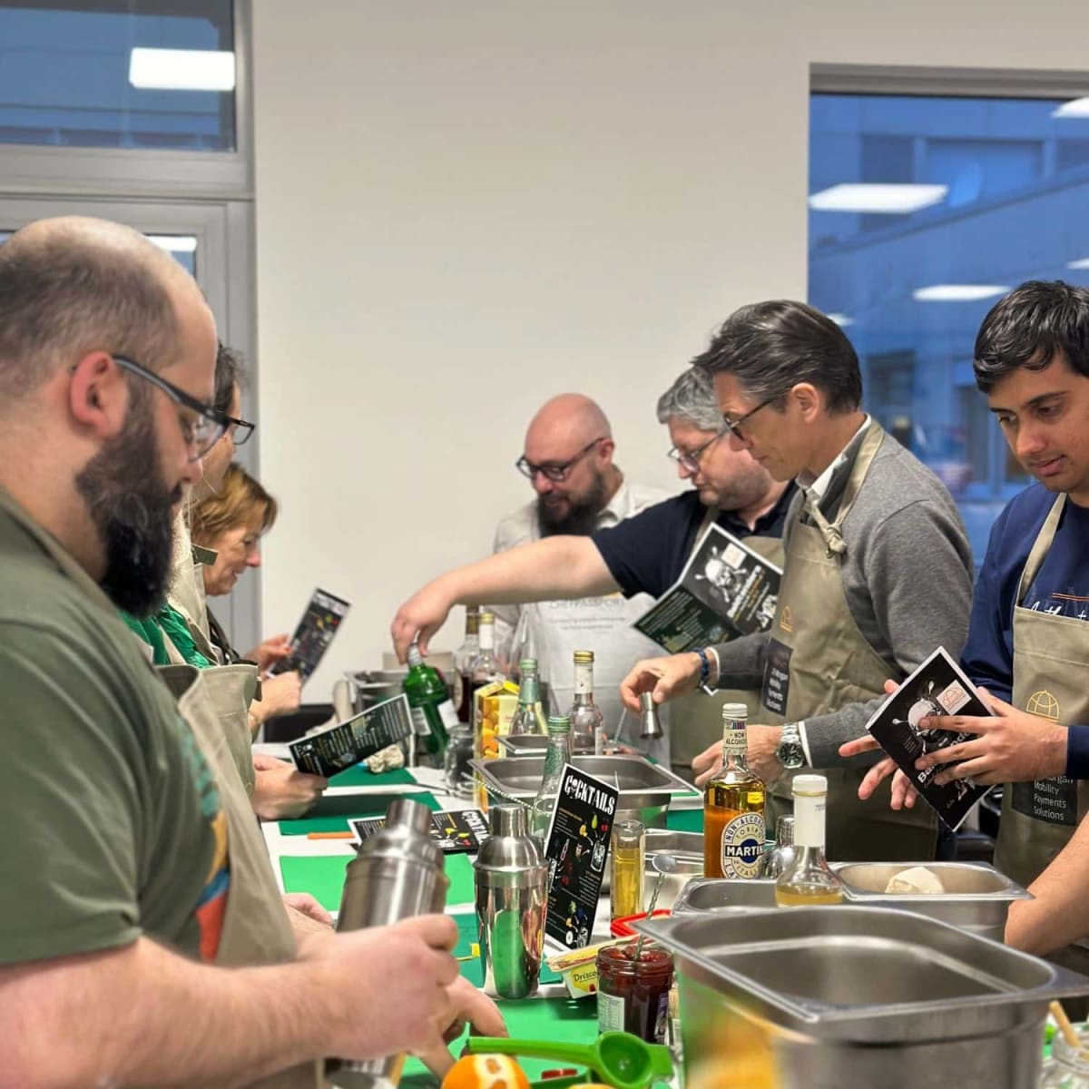 Participants engaged in hands-on cooking tasks during team building cooking class